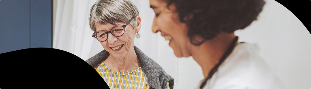 Elderly woman talking to a healthcare professional